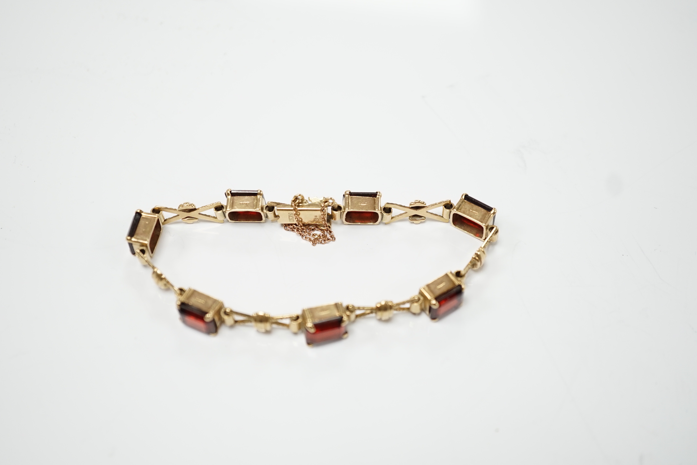 A 1960's 9ct gold and seven stone garnet set bracelet, by Cropp & Farr, 18cm, gross weight 17.9 grams.